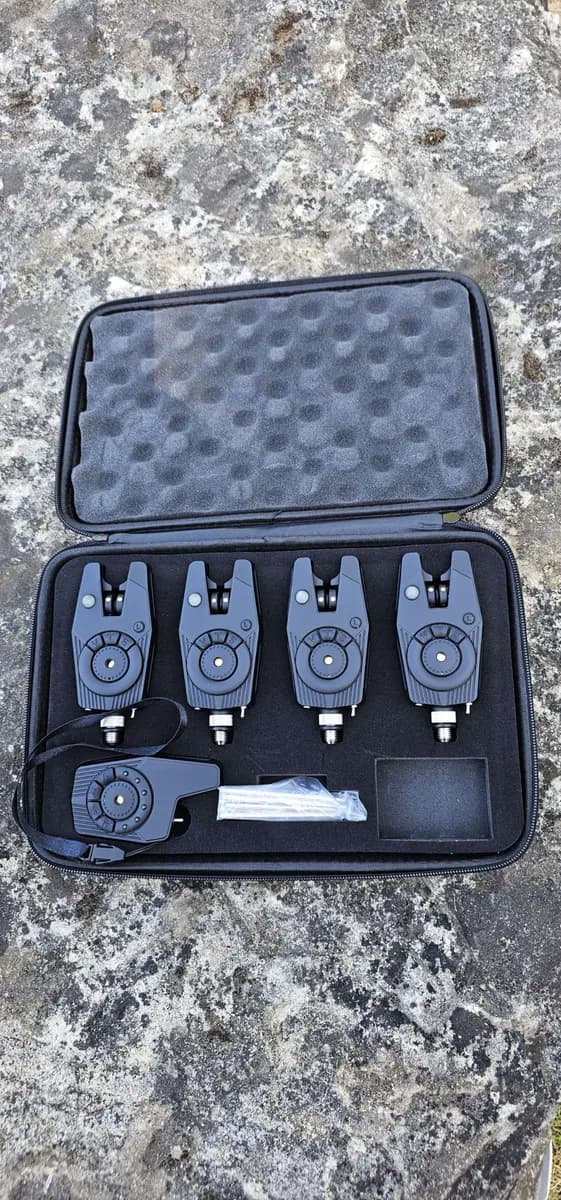 Carp fishing bite alarm on rod pod by a lake